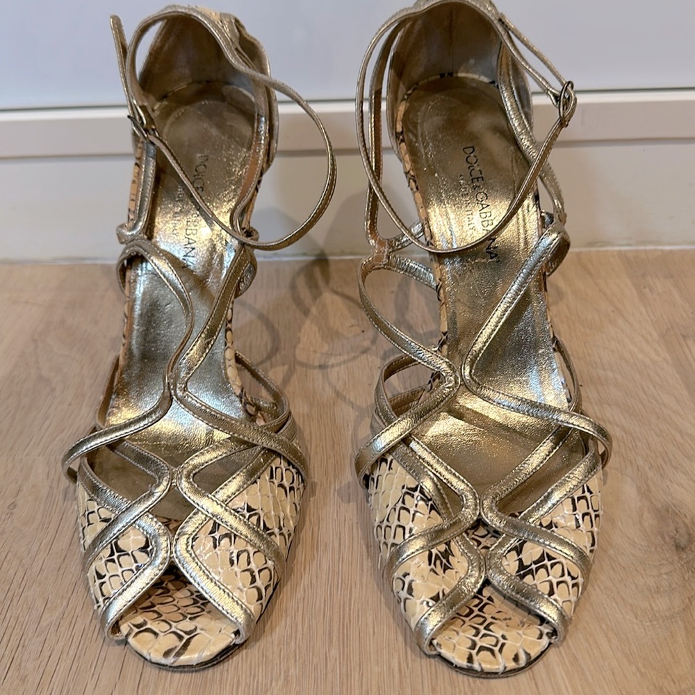 Dolce&Gabbana cream snakeskin strappy heels with gold leather trim.